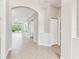 Bright foyer showcasing tile flooring, arched doorway, and access to the living area, creating an inviting entrance at 16101 Cape Coral Dr, Wimauma, FL 33598