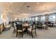 Brightly lit game room featuring multiple tables, chairs, and elegant chandelier lighting at 16101 Cape Coral Dr, Wimauma, FL 33598