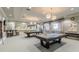 Spacious game room with two pool tables, seating, and a mirrored wall for entertainment at 16101 Cape Coral Dr, Wimauma, FL 33598