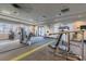 Modern gym with state-of-the-art equipment and windows with scenic views of the lake at 16101 Cape Coral Dr, Wimauma, FL 33598
