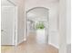 Bright hallway showcases an archway that leads to a spacious living area and a tiled floor at 16101 Cape Coral Dr, Wimauma, FL 33598