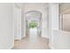 Bright entryway showcases an archway that leads to a spacious living area and a tiled floor at 16101 Cape Coral Dr, Wimauma, FL 33598