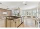 Open kitchen with granite countertops and stainless steel appliances overlooking the yard at 16101 Cape Coral Dr, Wimauma, FL 33598