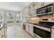 Well-appointed kitchen featuring stainless steel appliances, granite countertops, and designer cabinetry at 16101 Cape Coral Dr, Wimauma, FL 33598