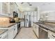 Modern kitchen with stainless steel appliances, custom cabinetry, and granite countertops at 16101 Cape Coral Dr, Wimauma, FL 33598