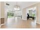 Spacious living room featuring tile floors, abundant natural light, and seamless access to outdoor spaces and other rooms at 16101 Cape Coral Dr, Wimauma, FL 33598