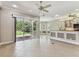 Spacious living room with sliding glass doors to the screened lanai and views of the backyard at 16101 Cape Coral Dr, Wimauma, FL 33598