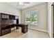 Bright office space with a built-in desk, storage, and a window with exterior views at 16101 Cape Coral Dr, Wimauma, FL 33598