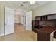 Office space featuring a ceiling fan and desk space, flowing into the dining room at 16101 Cape Coral Dr, Wimauma, FL 33598
