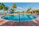 Large community pool with deck, umbrellas, plenty of seating, and a serene atmosphere at 16101 Cape Coral Dr, Wimauma, FL 33598