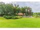 Attractive community sign with lush landscaping, greenery, and cascading water feature at 16101 Cape Coral Dr, Wimauma, FL 33598
