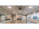 Yoga studio with wall mirrors, storage shelves, and laminate wood flooring at 16101 Cape Coral Dr, Wimauma, FL 33598