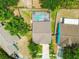 Aerial view of property showcasing a pool and well-maintained yard at 1758 Biarritz Cir, Tarpon Springs, FL 34689