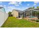 Spacious backyard featuring a screened lanai and inviting pool area at 1758 Biarritz Cir, Tarpon Springs, FL 34689