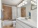 Cozy bathroom featuring a shower-tub combo with tiled walls and a single-sink vanity at 1758 Biarritz Cir, Tarpon Springs, FL 34689
