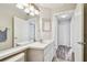 Bright bathroom featuring a white vanity, laminate floors and an open doorway leading to the hall at 1758 Biarritz Cir, Tarpon Springs, FL 34689