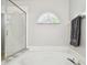 This bright bathroom features a soaking tub and a stylish window at 1758 Biarritz Cir, Tarpon Springs, FL 34689
