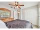 This bedroom has carpet floors, a ceiling fan, and built-in closet for ample storage space at 1758 Biarritz Cir, Tarpon Springs, FL 34689