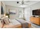 This bedroom has carpet floors, a ceiling fan, and built-in closet for ample storage space at 1758 Biarritz Cir, Tarpon Springs, FL 34689