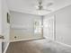 A spacious bedroom with gray walls, carpet floors, a ceiling fan, and a window for natural light at 1758 Biarritz Cirs, Tarpon Springs, FL 34689