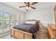 Cozy bedroom features natural lighting, wood furniture, and comfortable bedding at 1758 Biarritz Cir, Tarpon Springs, FL 34689