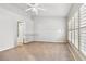 A clean, neutral-toned room, virtually staged with carpet flooring and shuttered windows at 1758 Biarritz Cir, Tarpon Springs, FL 34689