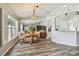 Bright dining area with wood floors, table, and light fixture plus large windows and a mirror at 1758 Biarritz Cir, Tarpon Springs, FL 34689