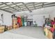 Spacious garage with epoxy flooring, washer, dryer, and plenty of storage space at 1758 Biarritz Cir, Tarpon Springs, FL 34689
