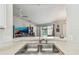 This kitchen features a view of the living area and pool at 1758 Biarritz Cir, Tarpon Springs, FL 34689