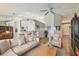 Comfortable living room with neutral decor, plush seating, wood flooring, and open to kitchen at 1758 Biarritz Cir, Tarpon Springs, FL 34689