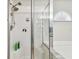 Bright, tiled shower area featuring glass door at 1758 Biarritz Cir, Tarpon Springs, FL 34689