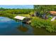 Aerial view of the backyard dock and boat lift, with the home's pool visible in the background at 1890 Wateroak W Dr, Clearwater, FL 33764