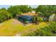 Aerial view of the screened-in pool and surrounding yard, showcasing lush landscaping at 1890 Wateroak W Dr, Clearwater, FL 33764