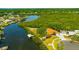Stunning aerial view of waterfront property with lush mangrove preserves and private dock at 1890 Wateroak W Dr, Clearwater, FL 33764