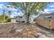 Backyard view with a large tree and detached RV parking spot at 1890 Wateroak W Dr, Clearwater, FL 33764