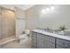 Modern bathroom with a gray vanity, marble countertops, and a tiled walk-in shower at 1890 Wateroak W Dr, Clearwater, FL 33764