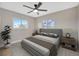 Well-lit bedroom with serene decor, two windows, and plush bedding for a relaxing atmosphere at 1890 Wateroak W Dr, Clearwater, FL 33764
