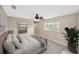 Cozy bedroom with neutral tones, soft lighting, and a large window for natural light and backyard views at 1890 Wateroak W Dr, Clearwater, FL 33764
