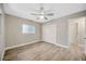 Bedroom featuring wood-look flooring, a window, a ceiling fan, and a closet with sliding doors at 1890 Wateroak W Dr, Clearwater, FL 33764