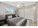 Cozy bedroom with a large window, a ceiling fan, and closet at 1890 Wateroak W Dr, Clearwater, FL 33764