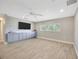 Bedroom featuring wood floors, a built-in wall unit, and a large window at 1890 Wateroak W Dr, Clearwater, FL 33764