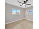 Bedroom featuring tile flooring and two windows providing natural light at 1890 Wateroak W Dr, Clearwater, FL 33764