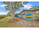 Side yard featuring kayak storage, set against a backdrop of lush greenery, showcasing an active lifestyle at 1890 Wateroak W Dr, Clearwater, FL 33764