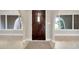 Inviting foyer with beautiful tile flooring, arched windows and a solid front door at 1890 Wateroak W Dr, Clearwater, FL 33764