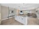 Bright kitchen featuring granite countertops, white cabinetry, and an open layout to the living area at 1890 Wateroak W Dr, Clearwater, FL 33764