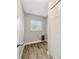A compact laundry room features a window for natural light and a convenient storage closet at 1890 Wateroak W Dr, Clearwater, FL 33764