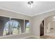 Bright living space featuring arched doorway and large windows showcasing the exterior at 1890 Wateroak W Dr, Clearwater, FL 33764