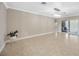 Living room with tile floors, modern lighting, and sliding glass doors to a back patio at 1890 Wateroak W Dr, Clearwater, FL 33764