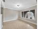 Bright, empty living room with tile floors and a large window for plenty of natural light at 1890 Wateroak W Dr, Clearwater, FL 33764