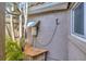 Exterior view of the outdoor shower with hot water heater at 1890 Wateroak W Dr, Clearwater, FL 33764